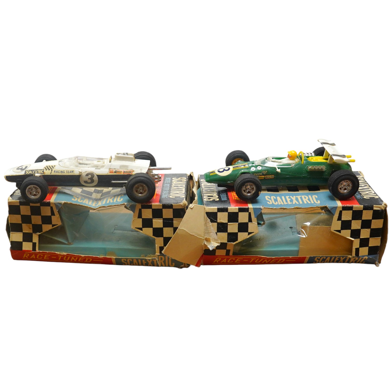 Two boxed 1960s Scalextric ‘race-tuned’ racing cars; a Lotus Indianapolis GP (C8) and a Scalextric Team Car (C19), both with inner card trays. Condition - poor, restoration needed to cars and boxes.